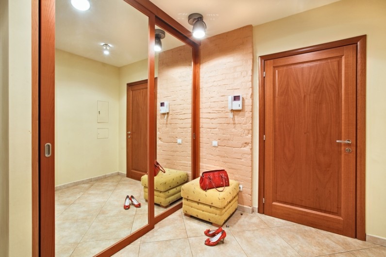 Elegance anteroom interior in warm tones with hallstand and mirror